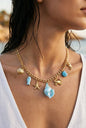 Gold nautical charm necklace with blue enamel, shell and star