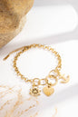 Golden stainless steel bracelet with anchor, heart, and helm charms
