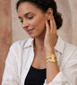 Elegant floral steel bracelet with sculpted golden petals